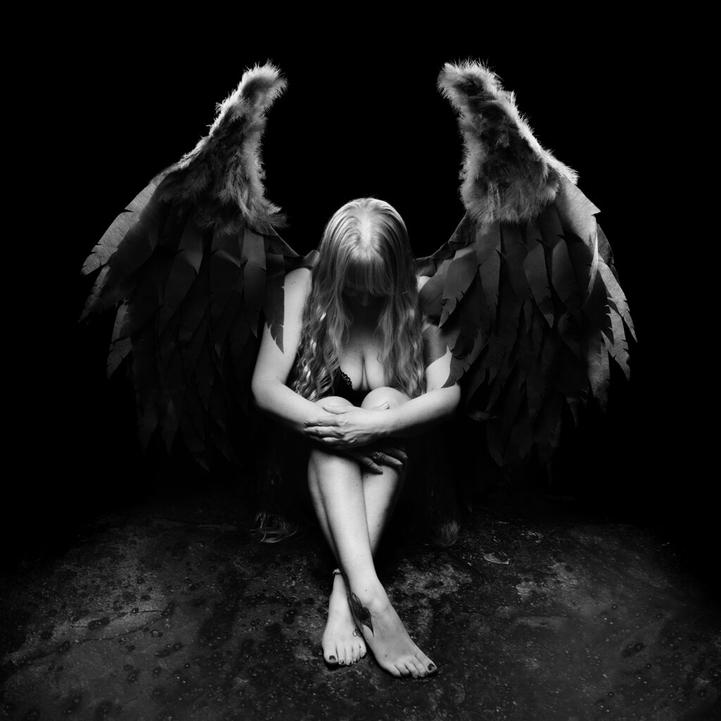 What to Expect from a Boudoir Photography Experience in Swansea Boudoir photography in Swansea — empowerment portrait of a woman with angel wings